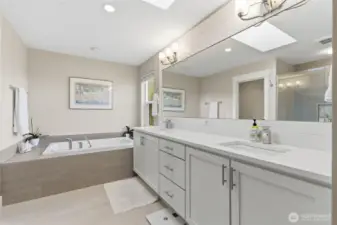 The primary bath features a luxurious soaking tub, perfect for unwinding after a long day. Elegant finishes and a spa-like atmosphere create a serene retreat right in your home.