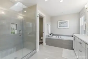 The primary bath includes a spacious walk-in shower, combining modern design with effortless functionality.