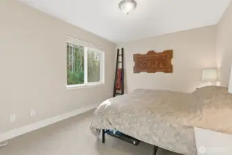 The guest room offers a cozy and inviting space for visitors, thoughtfully designed for comfort and is perfect for family, friends, or overnight stays.