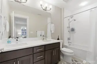 The guest bath is stylish and functional, featuring modern fixtures and a clean, inviting design. It provides comfort and convenience for visitors while complementing the home’s overall aesthetic.