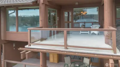 Deck looks out on the manicured large open lawn.