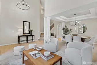 Front living room with gas fireplace, elegant millwork, and abundant natural light.