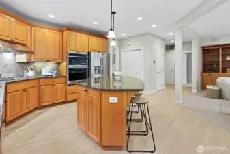 Front living room with gas fireplace, elegant millwork, and abundant natural light.