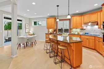 Front living room with gas fireplace, elegant millwork, and abundant natural light.