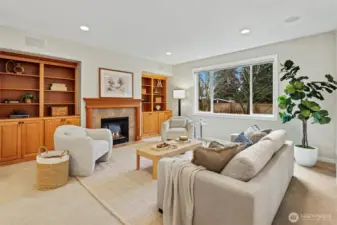 Kitchen flows seamlessly into family room with 2nd gas fireplace, built-in cabinetry perfect for storage, and pre-wired in ceiling speakers