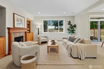 Kitchen flows seamlessly into family room with 2nd gas fireplace, built-in cabinetry perfect for storage, and pre-wired in ceiling speakers