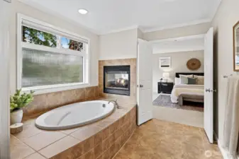 Spa inspired 5-piece ensuite with soaking tub, dual sided fireplace, rain shower head