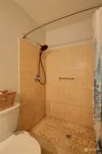 Beautiful, tiled step in shower in primary bathroom.