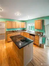 Spacious kitchen with large island with cook top.