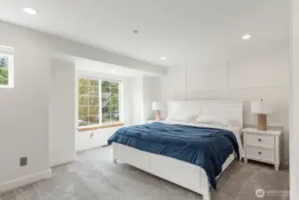 Large Primary Bedroom with lots of lighting.