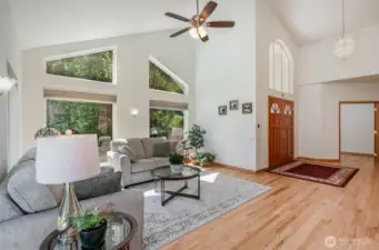To the right of entry, is the spacious living room with natural light beaming through these large picturesque windows.