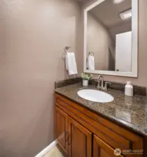 Powder room with granite counter.  Fan and faucet are both less than 3 years old