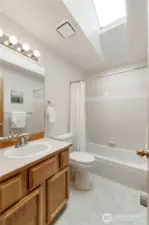 Upper level main bath with a skylight.
