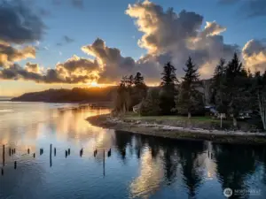 As the sun sets over the ocean to the west