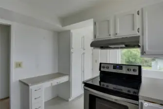 Kitchen has plenty of cabinetry for storage space and a small work desk for an online tasks.