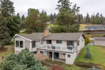 Home is a one-story home with a daylight basement perched on the hillside overlooking the entire Mariners Cove community.