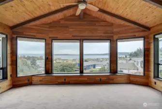 The large picture windows in the sunken indoor porch-like area with the vaulted ceiling and wood paneling, only accentuates the spectacular views one experiences.