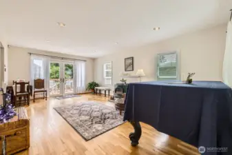 This spacious area can also be used as a living/dining room combo. French doors take you to the extra large entertaining deck for seamless indoor/outdoor living.