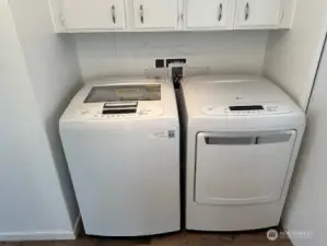 Full Sized Laundry with storage above.