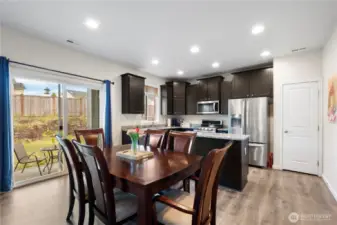 Dining area, stunning Dark brown cabinets, and generous granite countertops as well as an island!