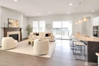 Cozy up by the gas fireplace in this stylish, open-concept living area.