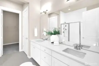 Roomy spa-like bathroom with dual sinks and modern finishes.