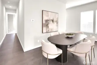 Natural light fills the living space, highlighting hardwood floors.