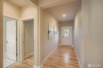 Foyer hall with entry to a 3/4 bath and main level bedroom or office.