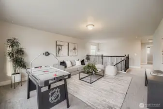 View across the upstairs loft toward the stairs and hall.