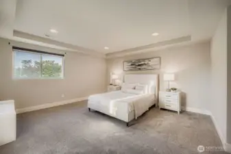 Primary bedroom with en suite bath and walk-in closet.