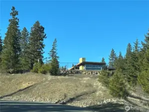 View looking up from Forest Ridge Drive at the under-construction clubhouse just above the sport court.