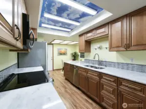 Newer faucet and double sink.  Lots cabinets for storage.