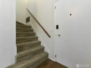 Front entry. Stairs going upstairs to bedrooms.