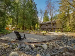 The back deck is made for entertaining & relaxing alike, surrounded by mature evergreens, native plantings, & the peaceful sounds of nature. This upper level would make a fantastic place to unwind and enjoy the great outdoors.