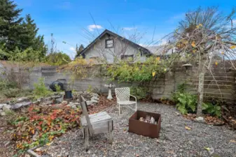 Amazing fire pit area with keyhole garden bed resting next to it. In the spring you will find honeysuckle and trumpet vine crawling the along the fence.