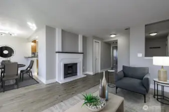 Open concept living freely flows from living room to dining and kitchen Virtually staged.