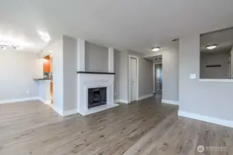Living room view of entry and hall to laundry and bedrooms.