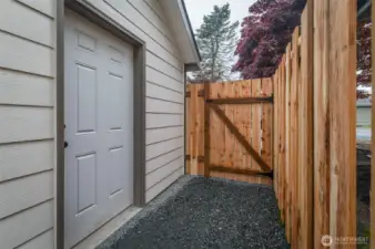 Close up of new fence and siding on side of storage/laundry room