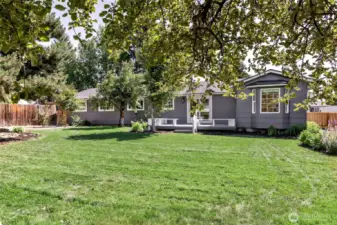 Large rear yard with mature landscaping.