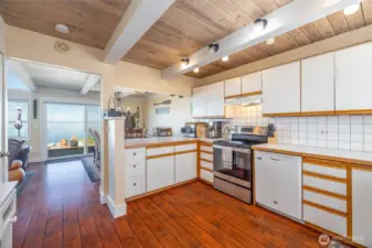 Kitchen opens to dining room with views.