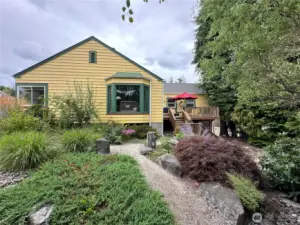 Here we have an early spring photo showing the large boulder lined walkways, ornamental grasses and perennial gardens.  The sundeck is conveniently located just off the kitchen making it perfect for your outdoor dining.