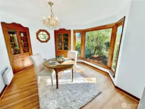 Lovely formal dining room features rich, oak floors, octagon window flanked by the original Mahogany built-in hutches and south facing bay windows.