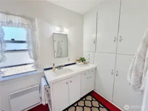 Primary 3/4 bath offers a wall of built-ins for all your towels & bath essentials and easy care Marmoleum flooring.