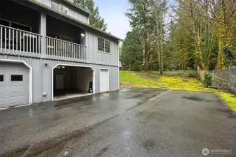 Tandem garage located on back side. On the right of it is extra storage. In the back is even more extra storage. And enjoy extra parking along side it.