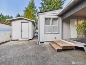 Covered back deck close to storage shed