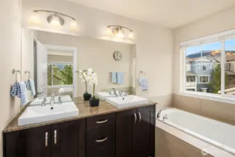 Large primary bathroom with dual vanities, soaking tub and separate walk-in shower enclosure