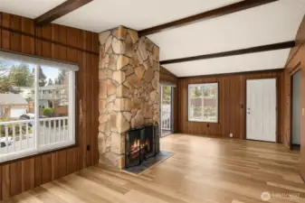 Family room with wood burning fireplace and vaulted ceilings faces southeast, allowing for plenty of natural light.