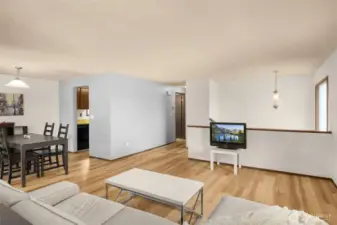 Peekaboo window from family room looks onto living room. Everything is connected yet has its own separate space.