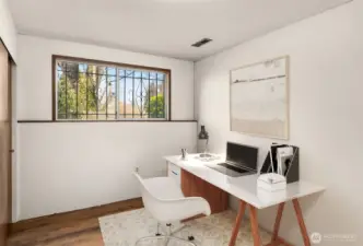 Downstairs bedroom or office space. This room is staged virtually.