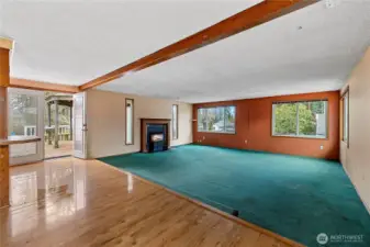 Open concept kitchen, dining and living area with french doors to the back deck.